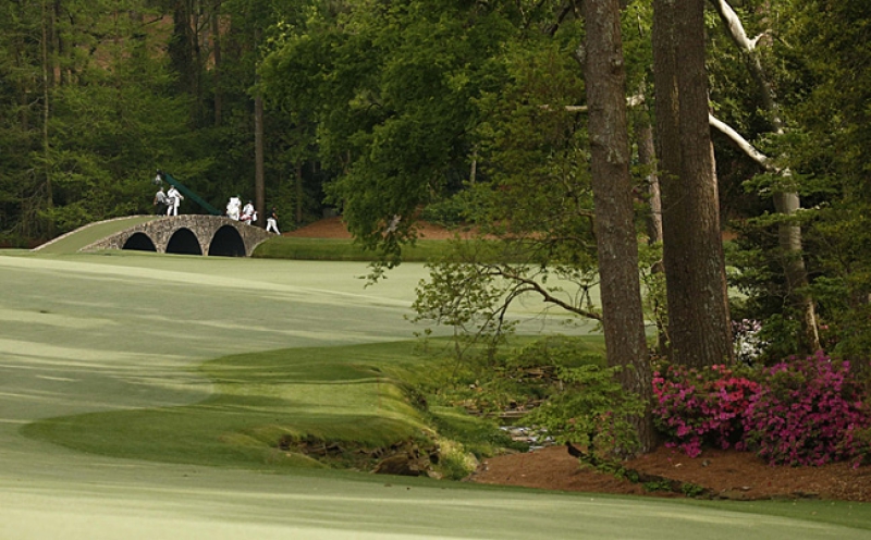 Apr 10, 2015; Augusta, GA, USA; Phil Mickelson leads his group across the Hogan Bridge on the 13th green during the second round of The Masters golf tournament at Augusta National Golf Club. Mandatory Credit: Rob Schumacher-USA TODAY Sports