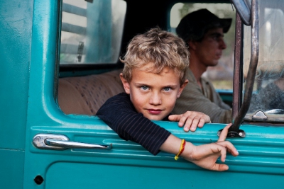 _DSC4677, Lavazza, Lambari, Brazil, 08/2010, BRAZIL-10106NF3. A young boy looks out the window of a truck.final print_MonzaPORTRAITS_APPretouched_Sonny Fabbri 11/2014